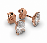 Angled side view of oval lab grown diamond stud earrings in rose gold showing prong setting